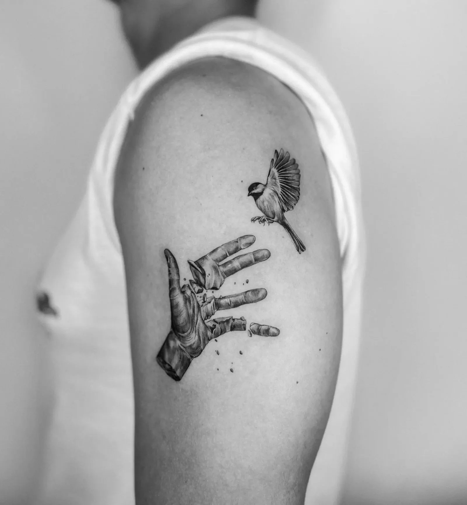Tattoo 04: hand and bird on the upper arm