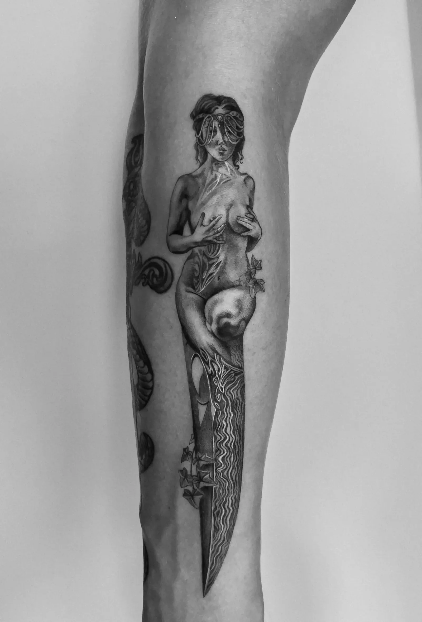 Tattoo 05: figure with a blade on the forearm