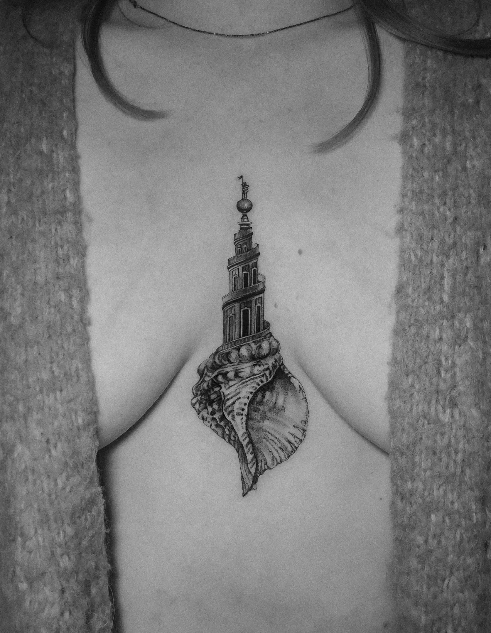 Tattoo 14: shell and spire on the sternum